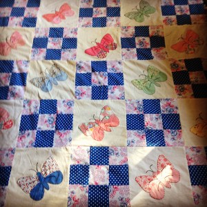 The butterfly blocks combined with nine patch blocks.