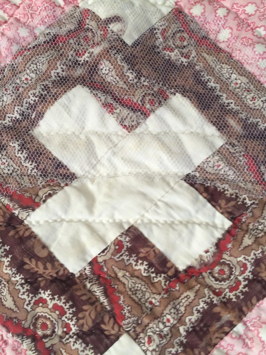 Tulle stitched onto the quilt to protect a fragile area.